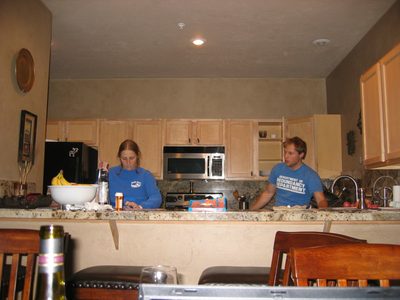 Catherine and John continuing to cook dinner.