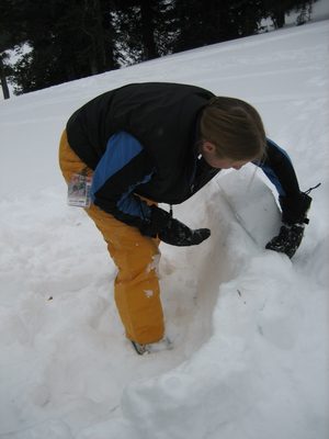 Catherine, placing a brick on the first layer of her igloo.
