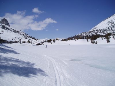 Crossing a frozen (Rae) lake.  Fin Dome at far left.