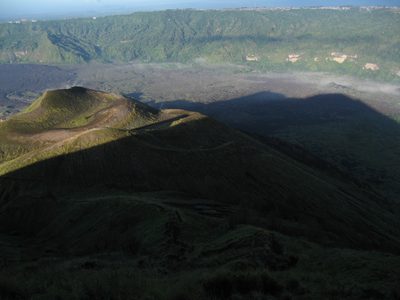 Gunung Batur's shadow cast across the devastated area...